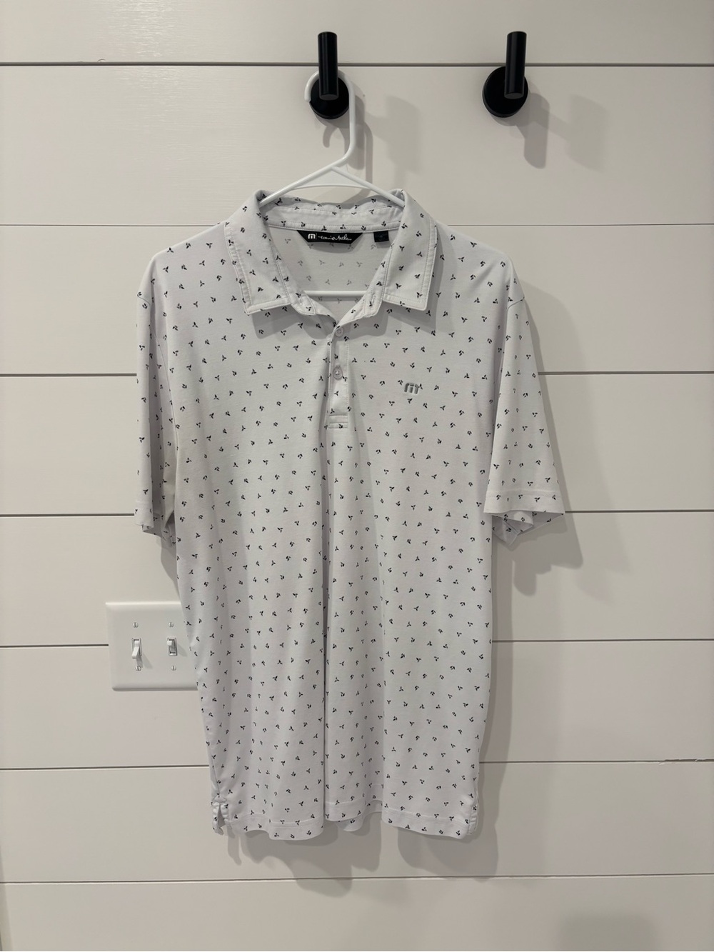 Travis Mathew White Polo with Small Black Motif
